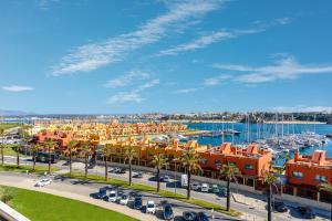 a marina with a bunch of buildings and boats at Vista Rio - apartamento in Portimão