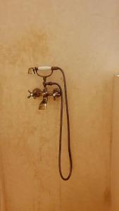 a shower head on a wall in a bathroom at Dar Malwan in Marrakech