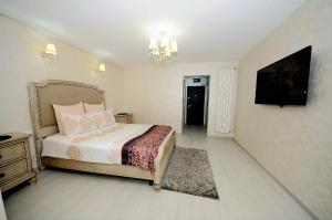 a bedroom with a bed and a flat screen tv at Apartament Panoramic in Galaţi