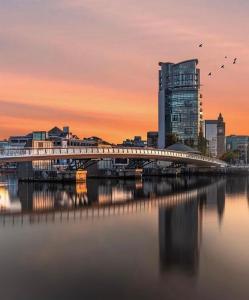 a bridge over a river in a city with a building at LoughView BED & BREAKFAST in Belfast