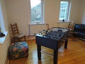 a living room with a large chess table in a room at Haus am Wald Zorge 16+ Gäste in Walkenried