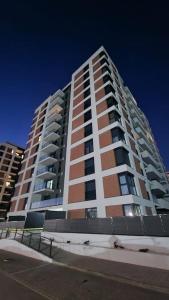 a tall apartment building on the side of a street at Apartament Adora Alex in Arad