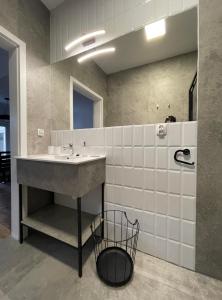a bathroom with a sink and a mirror at Apartament Arte Povera in Słubice +24 photos