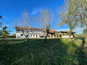 a large white building with trees in front of it at Beinalot Country House in Bene Vagienna