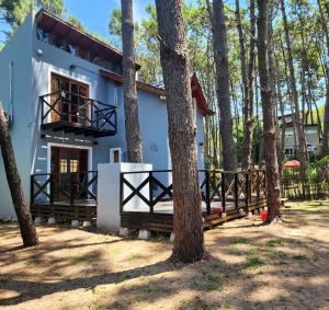 a house with trees in front of it at Sueños de Mar in Mar Azul