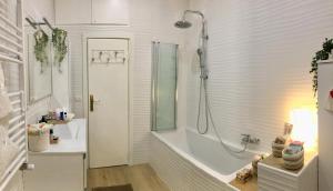 bagno bianco con vasca e doccia di Gemelli-San Pietro-Trastevere-casa con posto auto a Roma