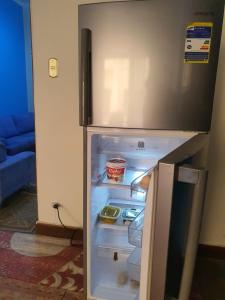 an empty refrigerator with its door open in a room at Special Room in downtown Cairo in Cairo