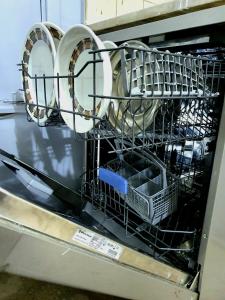 a dishwasher with plates and dishes in it at Special Room in downtown Cairo in Cairo