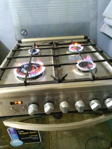 a stove with three pizzas on top of it at Special Room in downtown Cairo in Cairo
