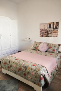 a bedroom with a bed with a floral bedspread at CASA MINGO in Teguise