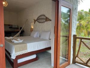 a bedroom with a bed and a sliding glass door at Casa di Maria flats in Icaraí +38 photos