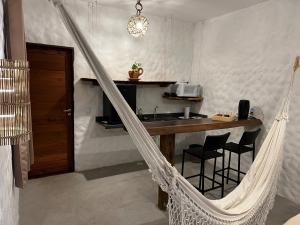 a hammock in a room with a kitchen at Casa di Maria flats in Icaraí