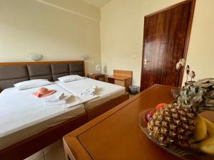 a bedroom with a bed and a bowl of fruit on a table at Villa Meresi - Thassos Town Center in Limenas