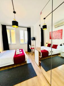 a bedroom with two beds and a desk at Aram Galata Suites in Istanbul