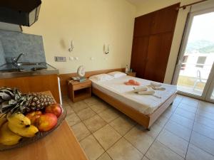 a bedroom with a bed and a bowl of fruit on a table at Villa Meresi - Thassos Town Center in Limenas