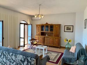 a living room with a blue couch and a table at Guesthouse Villa Rosa Berat in Berat