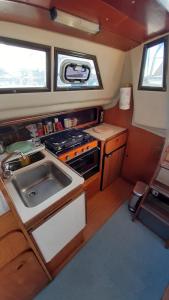 a small kitchen with a stove and a sink at Bed & boat brezza del mare in Viareggio