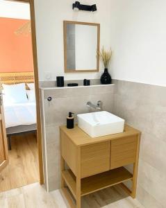 uma casa de banho com um lavatório e um espelho em Maison climatisée toute équipée em Montchanin