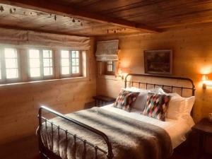 a bedroom with a bed in a log cabin at Boutique Chalet Panoramic Views Hot Tub in Vers L'Eglise +78 photos