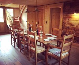 a wooden table and chairs in a room with a staircase at Boutique Chalet Panoramic Views Hot Tub in Vers L'Eglise