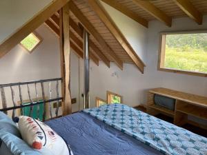 a bedroom with a blue bed and a window at Refugio Huerta Los Maquis in Puerto Guadal +23 photos