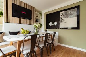 a dining room with a white table and chairs at south view in Bournemouth