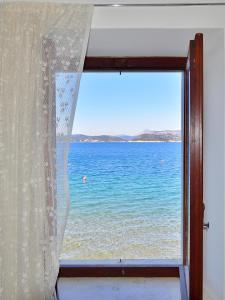 a window with a view of the ocean at Dream Beloc House Lopud Island in Lopud Island