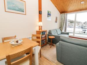 a living room with a couch and a table at 1 South Snowdon Wharf in Porthmadog