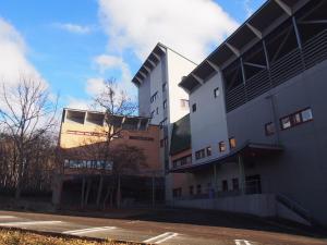 a building with a parking lot in front of it at Aizu Kogen International Human Resources Center - Vacation STAY 34873v in Minamiaizu