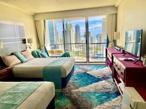 a hotel room with two beds and a view of a city at High Floor Ocean View at Surfers Paradise - Hotel Studio in Gold Coast