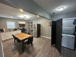 a kitchen with a table and chairs in a room at Hess St in San Antonio