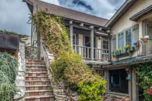 an ivy covered house with stairs at 3796 The Madden Suite apts in Carmel