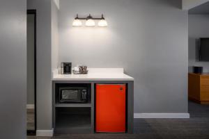 a kitchen with an orange refrigerator and a counter at Tamarack Lodge in Ketchum