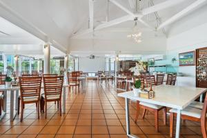 a dining room with tables and chairs at The Resort at Dolphin Heads in Mackay