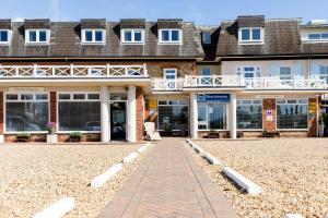 a woman sitting in front of a building at The Beachcroft Hotel, BW Signature Collection in Bognor Regis +109 photos