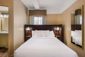 a large white bed in a hotel room at Best Western Syracuse Downtown Hotel and Suites in Syracuse +23 photos