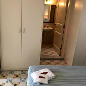 a bathroom with a towel on a bed and a sink at Borgo Antico di Capri in Capri