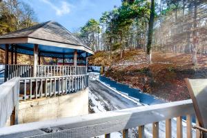 a gazebo with a fence next to a forest at Bella Paradiso 11 in Eureka Springs