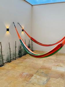 a hammock hanging on a wall in a room at Casa Flecheiras 52 in Flecheiras