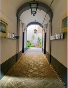 an empty hallway with an archway in a building at Central House Catania historic Center in Catania