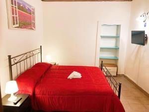 a bedroom with a red bed with a red blanket at Central House Catania historic Center in Catania