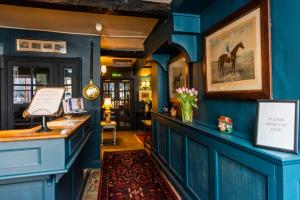 a room with blue walls and a counter with flowers at The George Inn in Oakham