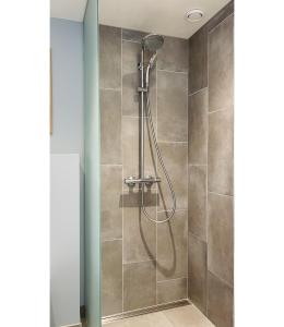 a shower with a shower head in a bathroom at ApartmentInCopenhagen Apartment 1525 in Copenhagen +25 photos