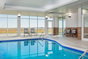 a swimming pool with chairs in a building at Fairfield Inn & Suites by Marriott McPherson in McPherson