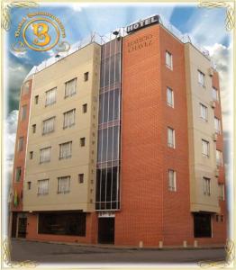 a large brick building with a sign on it at Hotel Buenaventura in Pasto