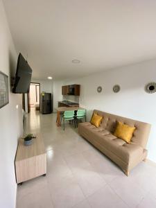 a living room with a couch and a table at Jardín de Primavera Apartamentos in Jardin