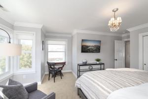 a bedroom with a bed and a desk and a chair at 3813 Point Break home in Pacific Grove