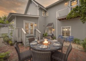 a patio with a table and chairs with a fire place at 3813 Point Break home in Pacific Grove