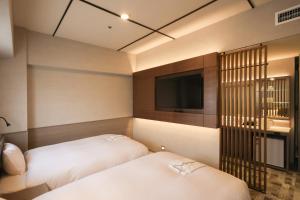 Postel nebo postele na pokoji v ubytování SK HOTEL Kobe Ekimae