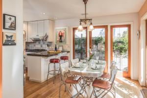 a kitchen and dining room with a table and chairs at 3743 Pelican Peaks home in Pacific Grove